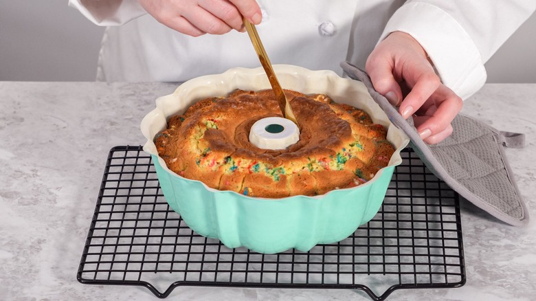 Cutting into funfetti bundt cake