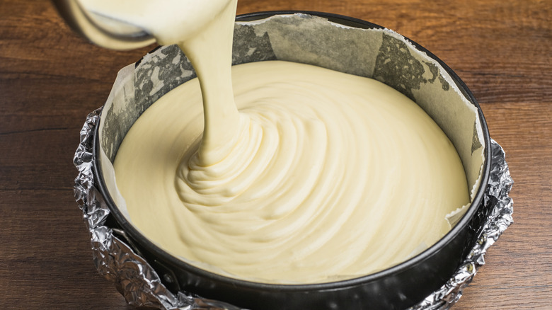 Pouring cake batter into pan