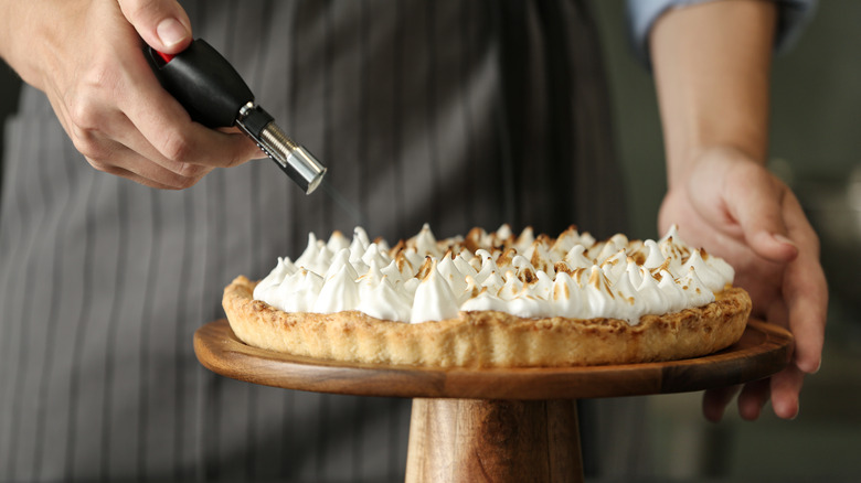 Toasting a lemon meringue pie