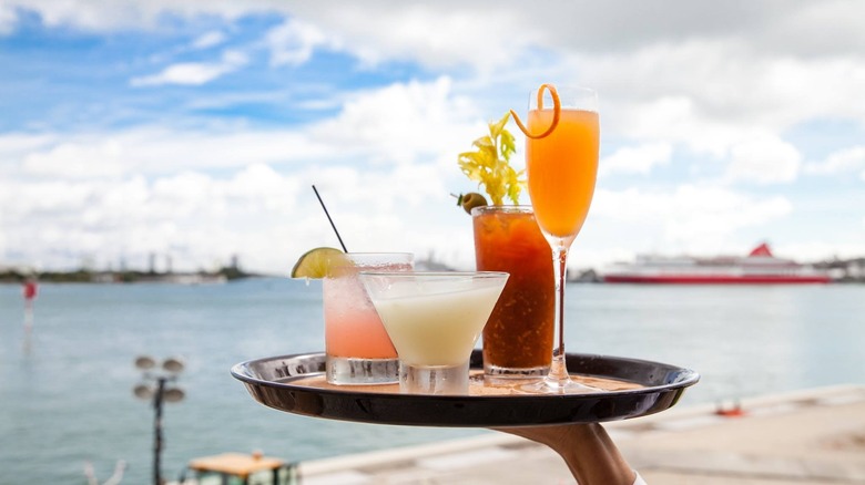 tray of cocktails on waterfront