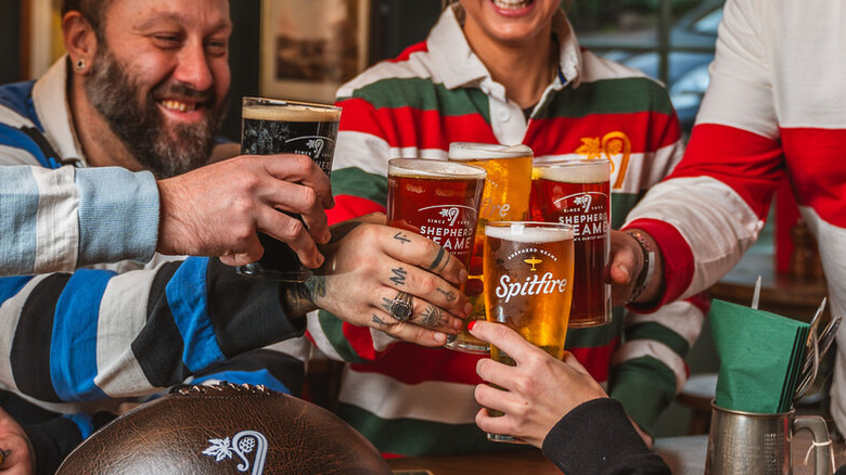 Group of friends sharing a selection of Shepherd Neame beers