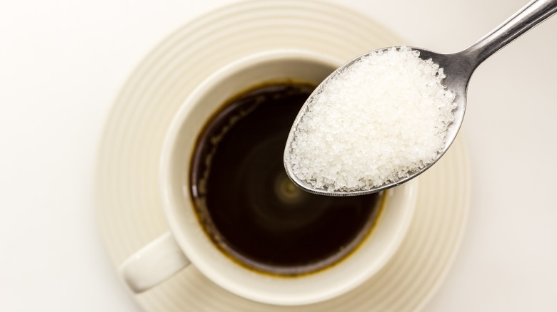 Sugar poured into coffee