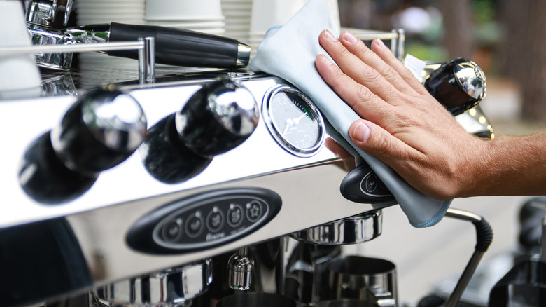 Barista cleaning espresso machine