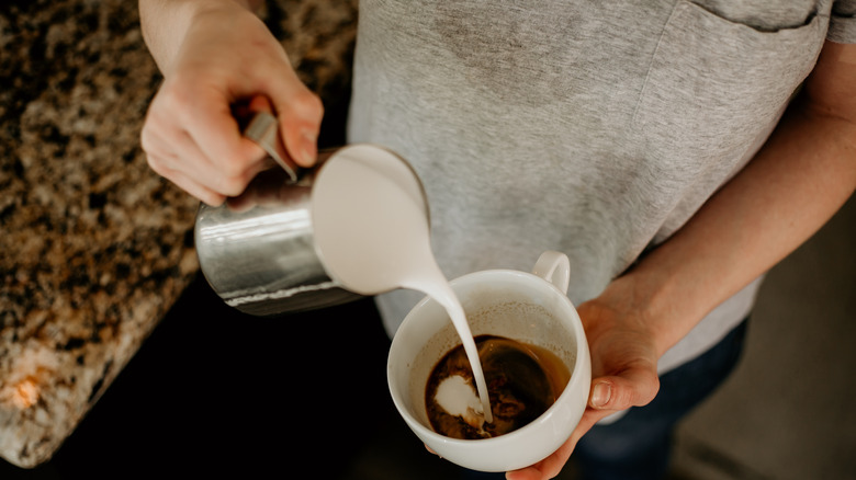 Pouring milk into coffee