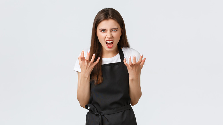 Angry barista in apron