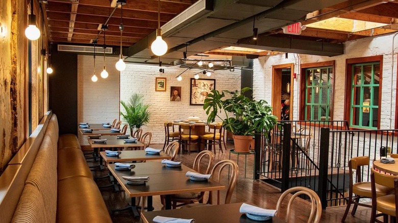 Wooden chairs, tables, green plants