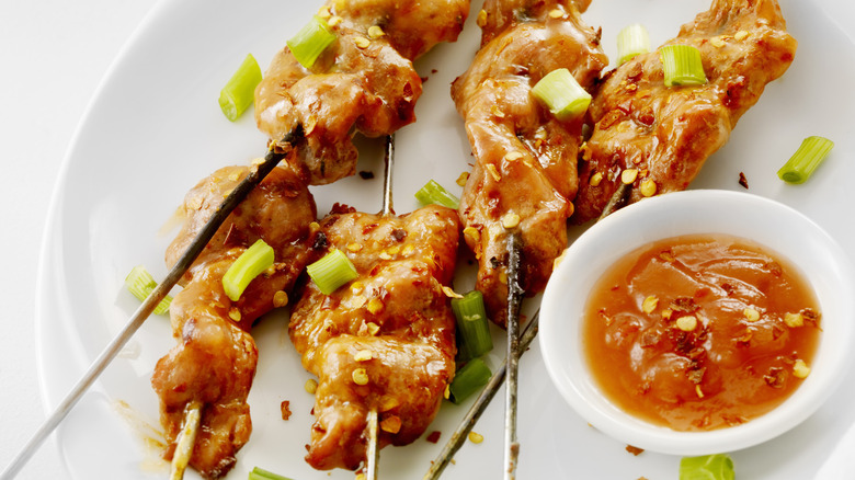 Sweet and sour sauce with chicken skewers