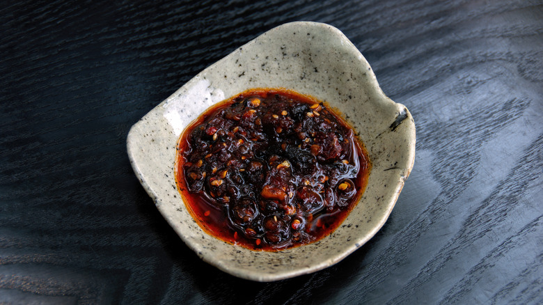 Chili crisp oil in a rustic ceramic bowl