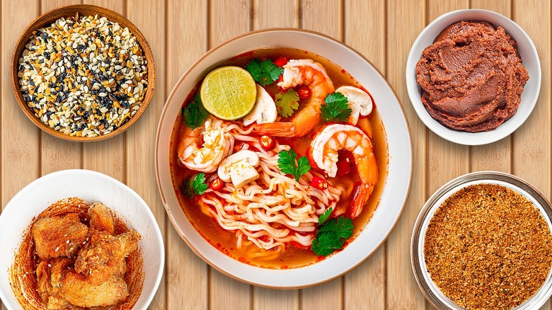 Shrimp and vegetable ramen in a bowl surrounded by various seasonings