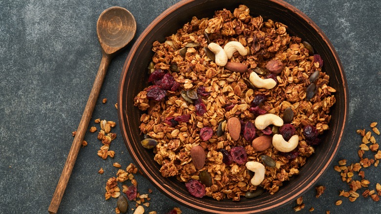 Bowl of pumpkin granola with dried fruit and nuts