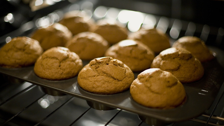 Tray of freshly baked pumpkin muffins in the oven