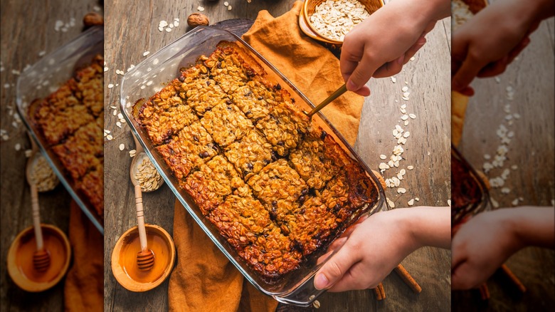 Serving baked oatmeal slice from glass dish