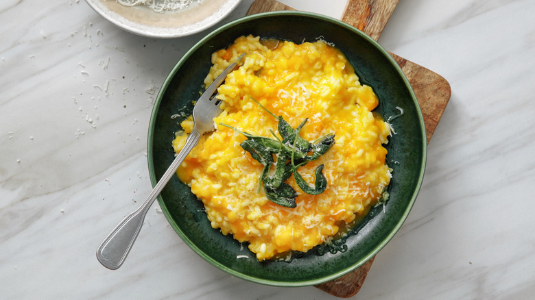 Bowl of pumpkin risotto with sage leaves