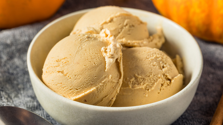 Three scoops of pumpkin ice cream in a bowl