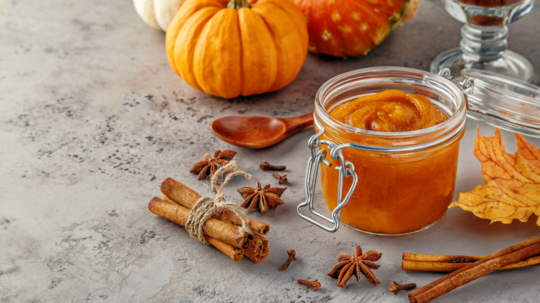 Jar of pumpkin butter with fall-inspired decorations