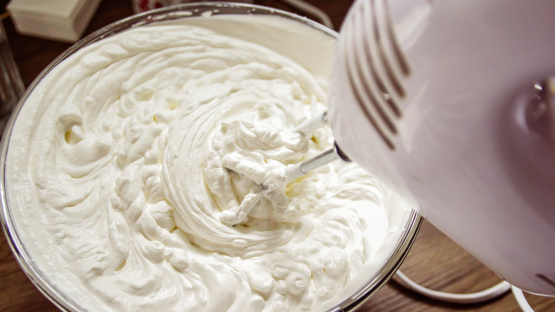 Beating whipped cream with an electric mixer