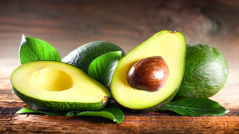 Avocados on wooden surface