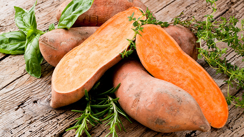 Sweet potatoes on wooden surface