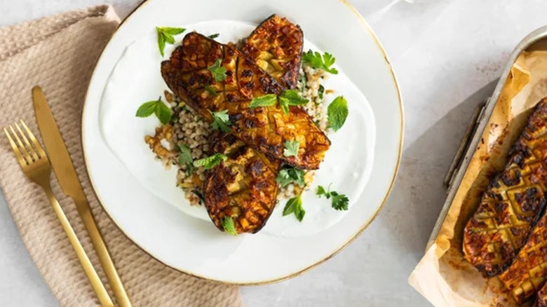 Top-down view of plated zucchini with couscous and harissa