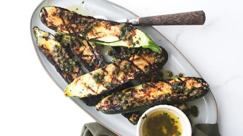 Top-down close-up of plated zucchini with capers