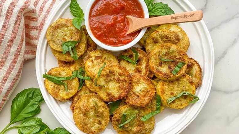 Top-down view of plated Italian fried squash and sauce