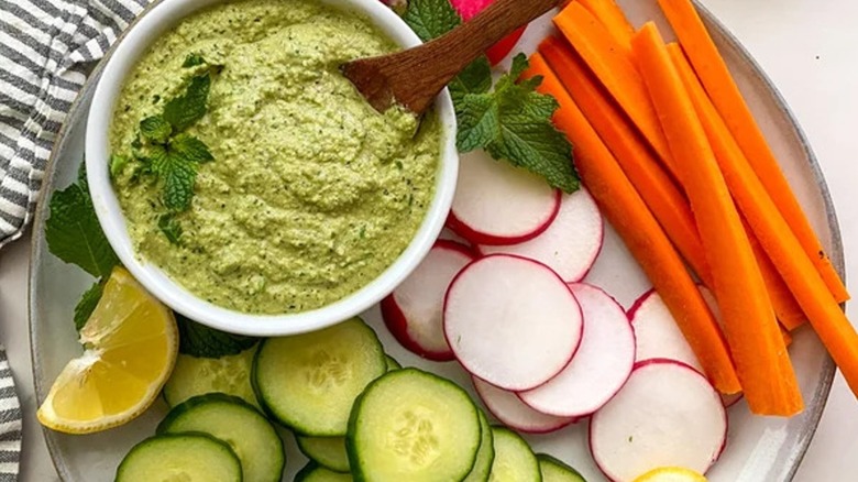 Top-down view of zucchini hummus and vegetables