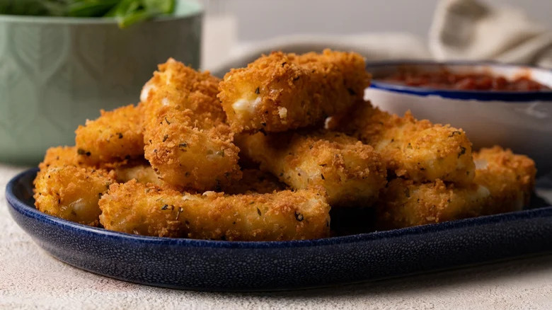 Mozzarella sticks on blue plate