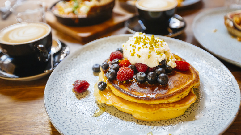 Ricotta pancakes are displayed on a plate.