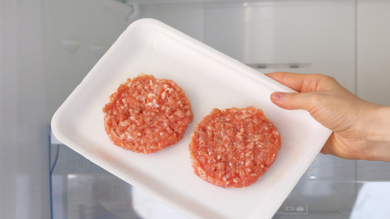 plate of burgers in refrigerator