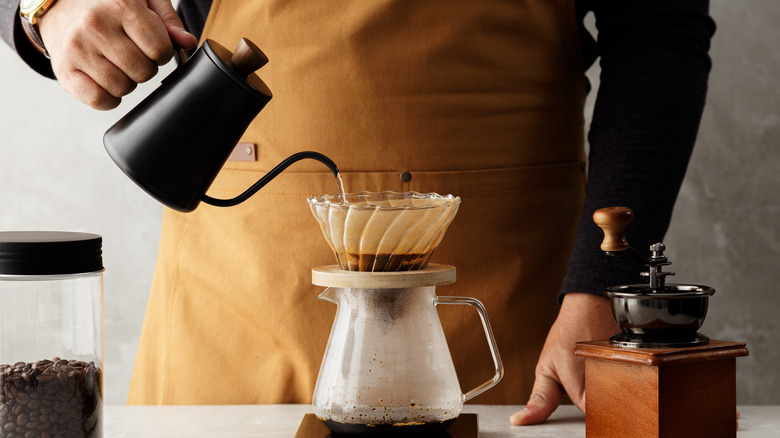 Person making drip coffee