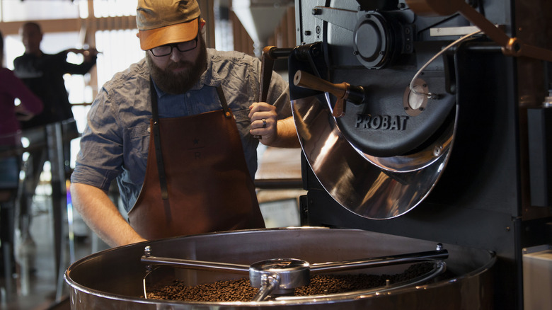 Person roasting coffee in machine