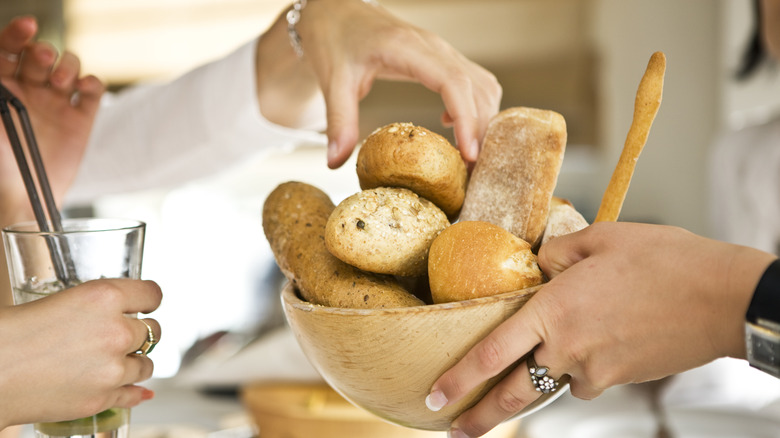 Person picking bread from bowl