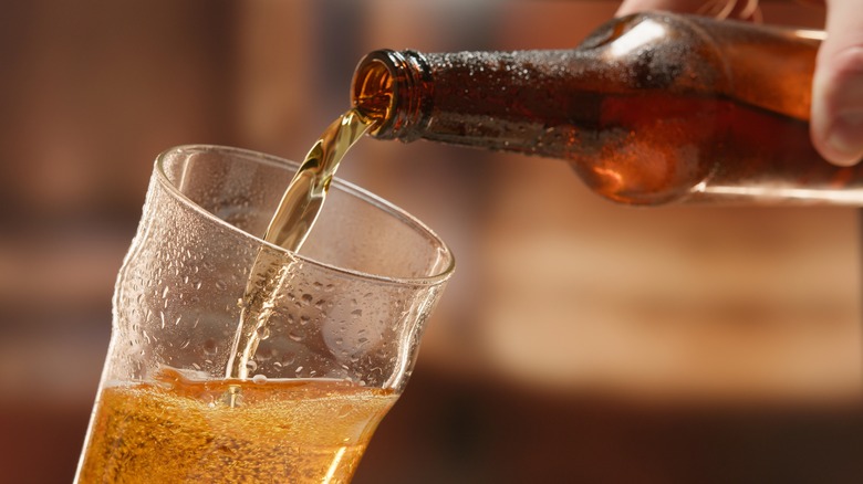 Bottled beer being poured into glass 