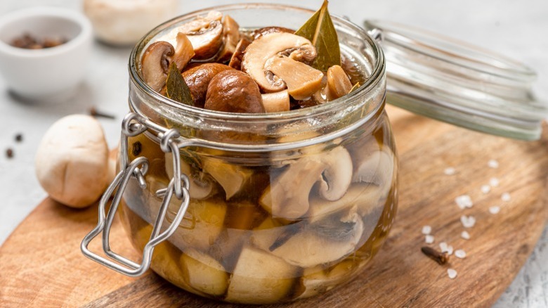 Marinated mushrooms in glass jar