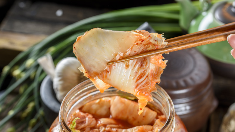 pulling kimchi out of jar