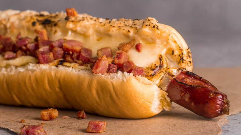 Hot dog with bacon and melted cheese