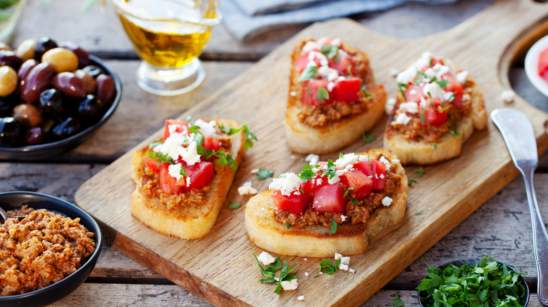 Tapenade and tomatoes on crostini