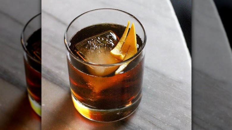 Whiskey drink with orange peel