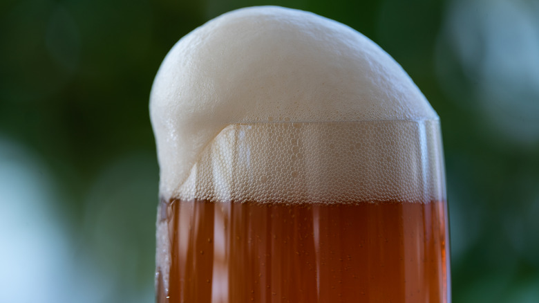 Foaming glass of amber beer