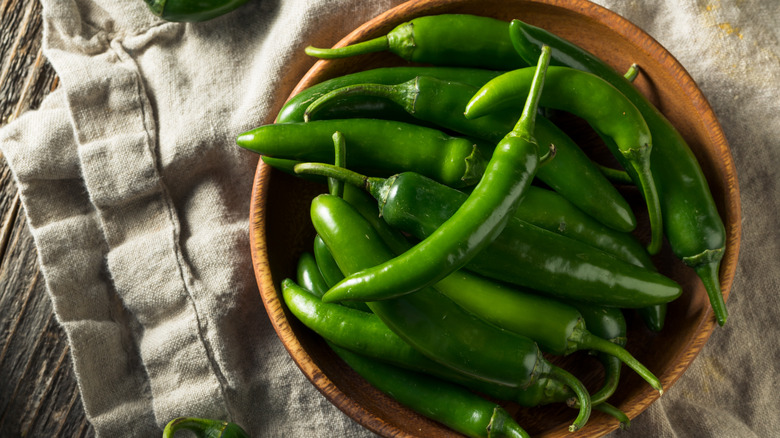 Green serranos in wooden bowl