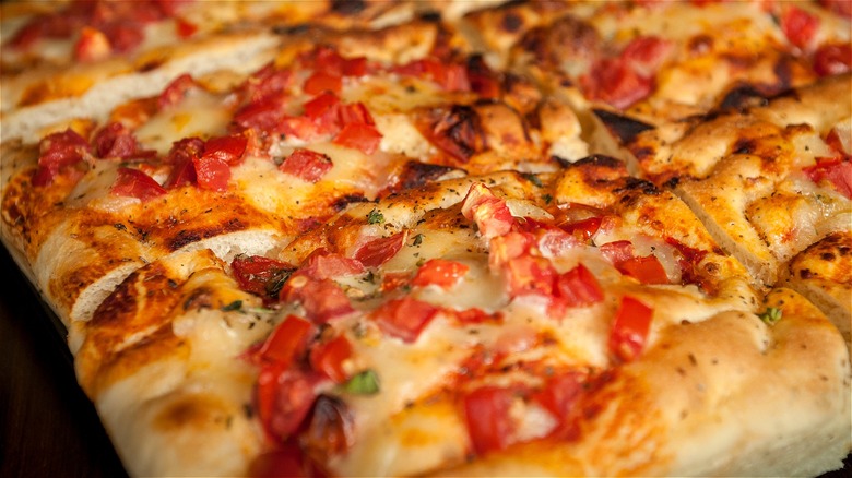 Pizza al taglio with cheese and tomatoes