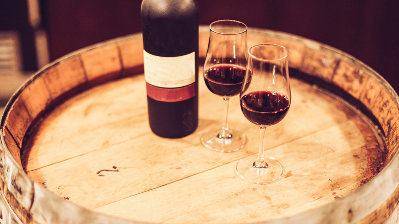 port bottle and glasses on barrel