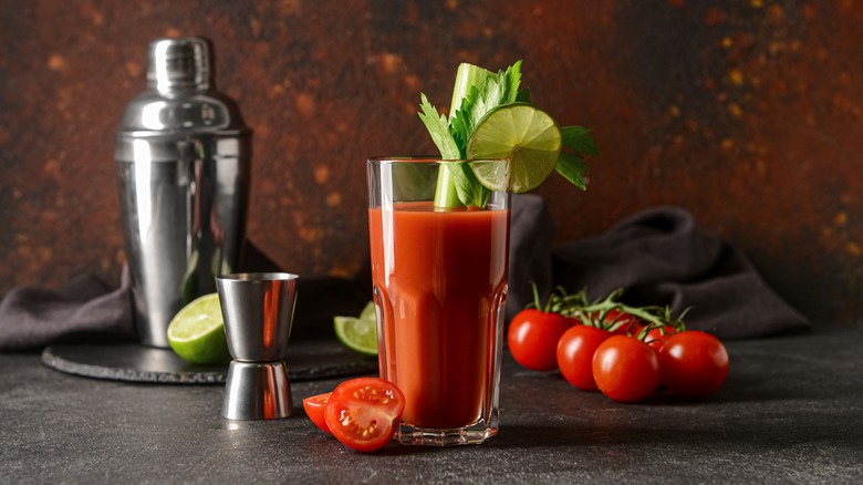 Bloody Mary with shaker, jigger, and tomatoes