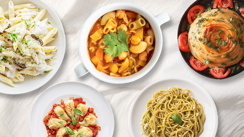 various italian pasta dishes laid out over tablecloth