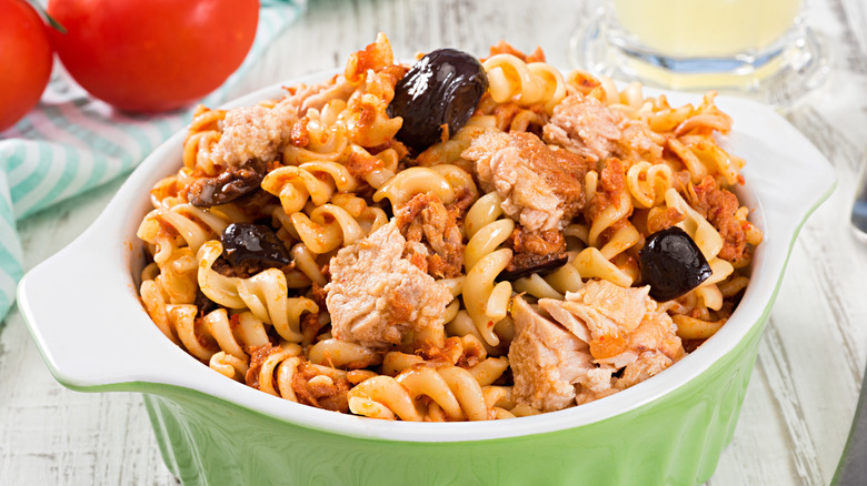 fusilli pasta in bowl with tuna and black olives