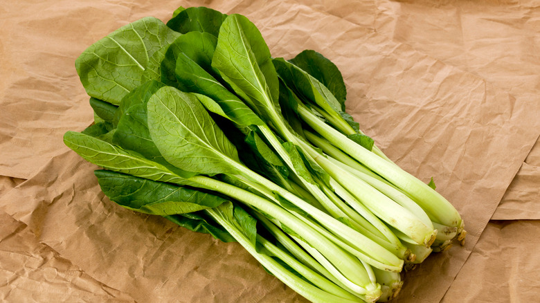 Mustard greens on brown paper