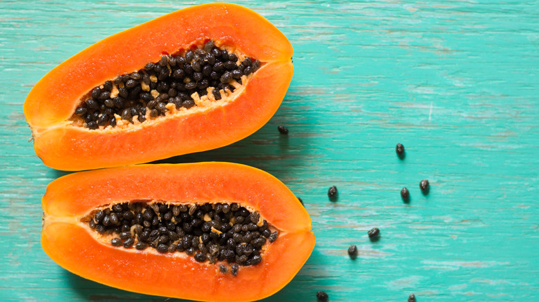 Cut papaya on blue background