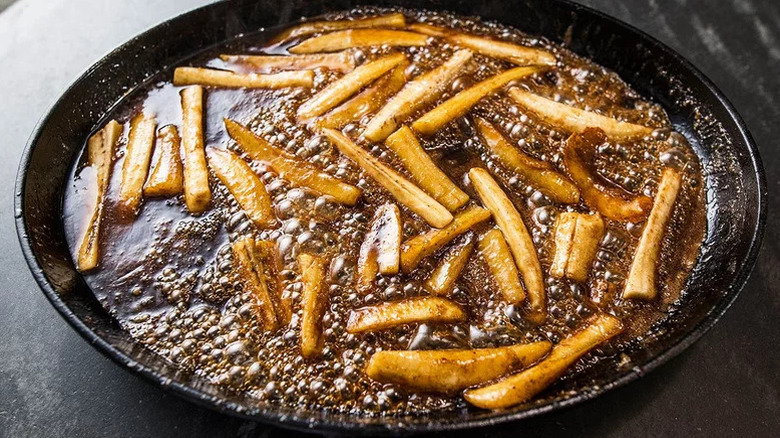 Bananas cooking in caramel sauce in a pan