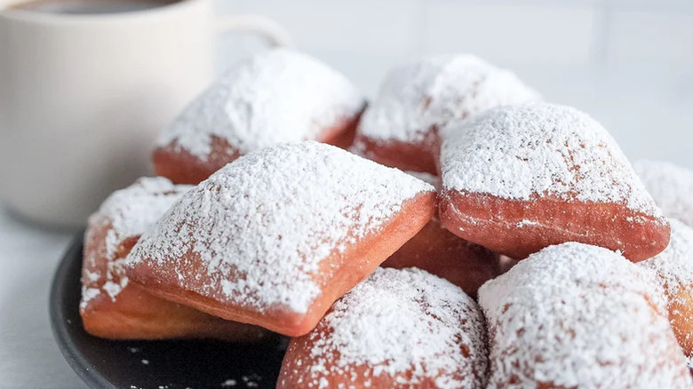 New Orleans beignets on a plate with powdered sugar