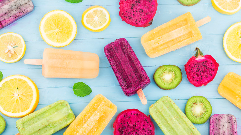 Colorful popsicles and fruit slices